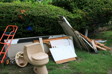 Construction Debris and Discarded Toilet in a Residential Yard
