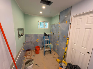 Home Bathroom Renovation Project Showing Tiled Walls and Tools in Progress