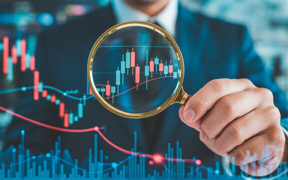 Business analyst examining financial charts through a magnifying glass for investment analysis and market trend investigation.