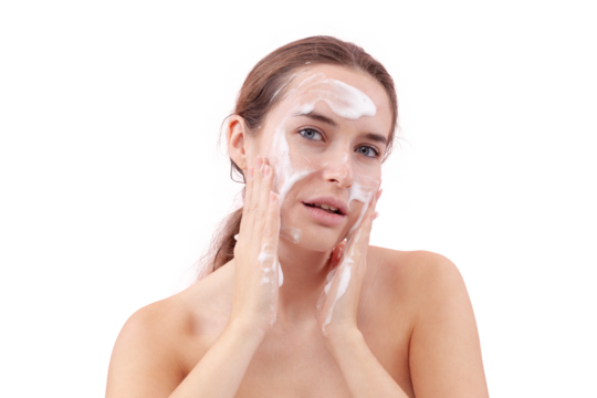 Close up of young woman cleansing her face with foaming cleanser, hands covered in foam while applying it to her skin. Skincare routine for clean, healthy face. Isolated on white background, acne care