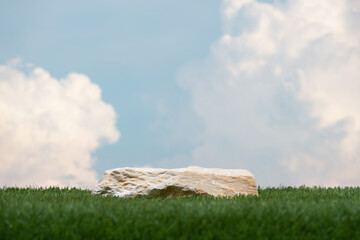 Surreal stone podium with green grass white clouds on blue sky nature forest background.Product...