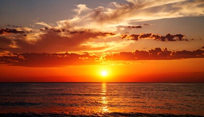 Obraz premium Fiery Sunset Over Calm Ocean.