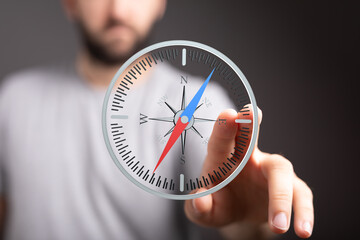 Close-up of a person interacting with a digital compass on a touchscreen.
