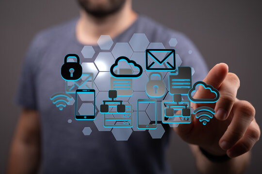 Image of a man interacting with a holographic projection of network icons, showcasing cloud computing, data security, and connectivity.