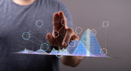 Person interacting with a digital graph showing data analysis, growth, and trends.