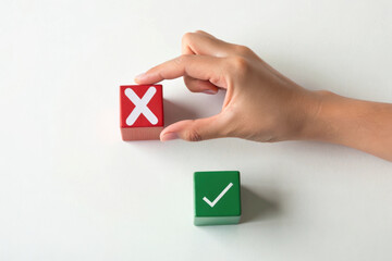 Hand choosing correct answer wooden blocks