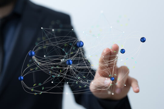 Stock photo of a businessman interacting with a digital network visualization, representing connection and global network. - Powered by Adobe