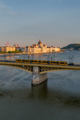 Scenic view of the famous Margit bridge acrossing over Danube river. Hungarian Parliament amazing building visible too in the photo