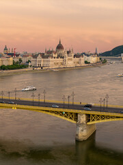 Scenic view of the famous Margit bridge acrossing over Danube river. Hungarian Parliament amazing building visible too in the photo