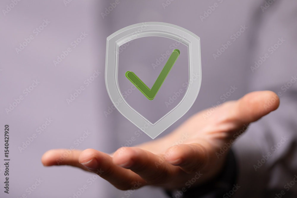 Poster hand holding a digital shield with a checkmark, symbolizing security and data protection.
