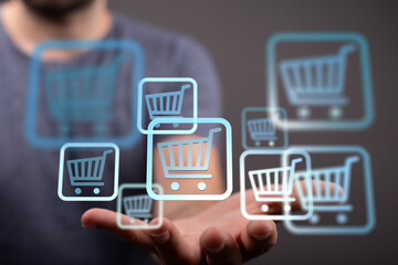 Hand holding multiple shopping cart icons, symbolizing online shopping and e-commerce.