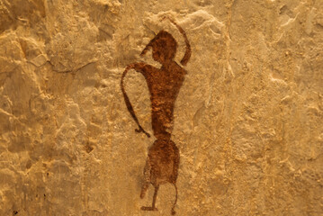 Rock art includes both human and animal figures on the cliff face at Tham Pha Thai National Park,...