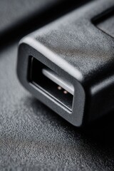 Close-up exploration of a sleek docking connector revealing intricate details and smooth textures illuminated by gentle light