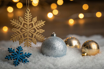 Silver and gold christmas ornaments with snowflakes and lights