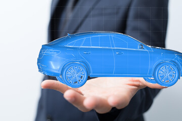 Image of a businessman holding a digital 3D model of a car, symbolizing automotive technology,...