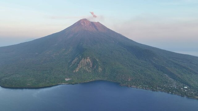 Daybreak illuminates the peak of Iliape volcano on Lembata Island in the Lesser Sunda Islands of Indonesia. This scenic volcano in the ring of fire has been extremely active since 2024.