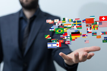 Image of a businessman connecting with various countries flags, symbolizing global reach and...