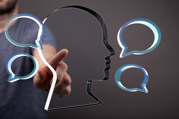 Conceptual image of a man interacting with digital speech bubbles, representing communication and...