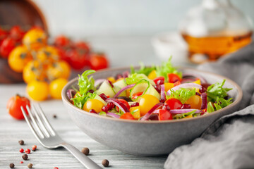 Easy vegetarian salad of fresh cucumber, tomato, sweet pepper,  onion  with pomegranate seeds. Healthy food.