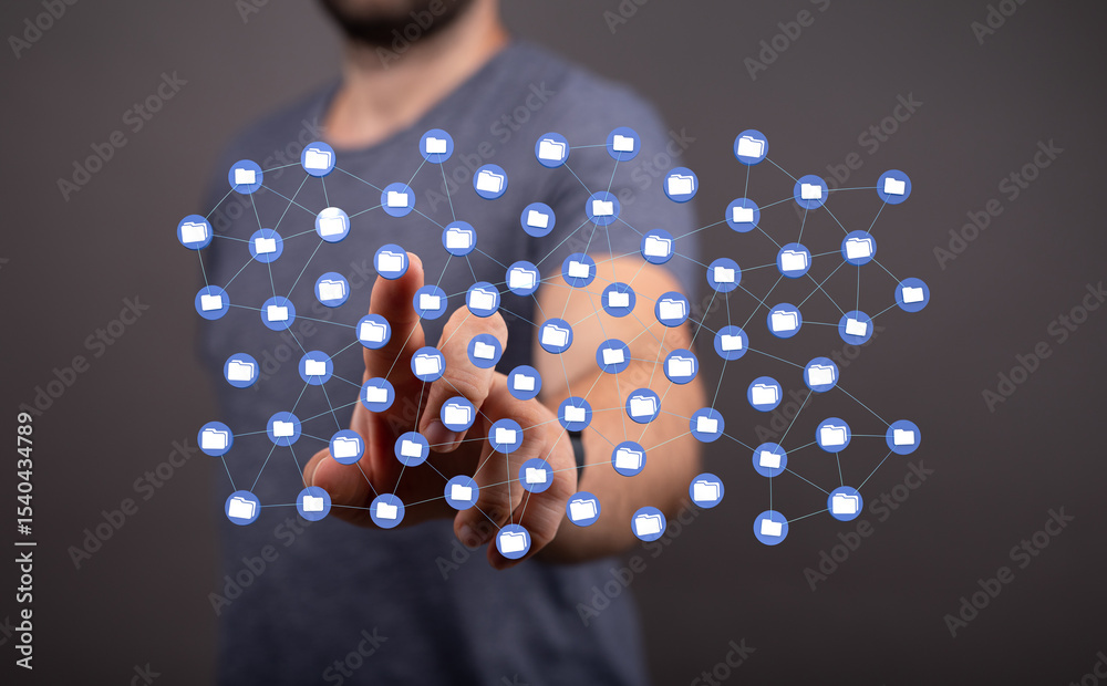 Poster conceptual image showing a man interacting with a network of digital folders, representing data mana