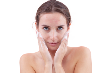 Close up of a young woman washing her face with hands covered in foam touching her skin. Deep cleansing skincare routine for clean, healthy skin. Isolated on white background, acne care concept