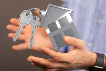 Image of house keys and a home model, perfect for real estate, housing, and property websites.
