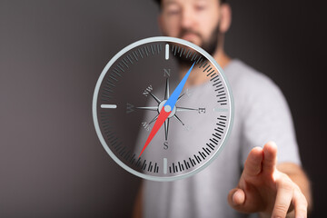 A man interacts with a digital compass, symbolizing guidance and decision-making.