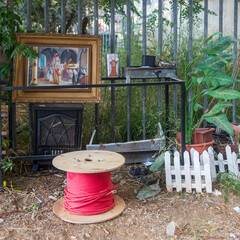 Petah Tikva, Israel, 12 June 2025, Miscellaneous Items and a Painting Against a Metal Fence. A place to relax in an abandoned area behind garages