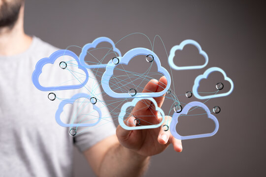Image of a hand interacting with a network of cloud icons, symbolizing data sharing and connectivity in cloud computing.