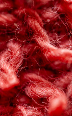 Red fabric fibers weaving an intricate textile tapestry