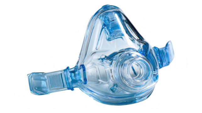 Full face cpap mask, made of transparent plastic material, isolated on a checkered background, offering a clear view of its design and components for respiratory support