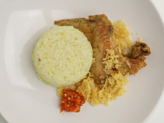 Savory rice served with fried chicken and chili sambal.