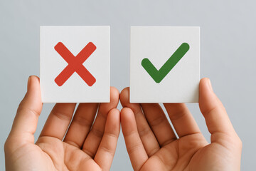 Decision making is illustrated by two small white cards featuring a red cross and a green checkmark held carefully in hands expressing choice and evaluation