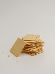 Square crackers piled on white background