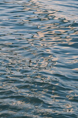 Golden blue sparkling water under the sunset