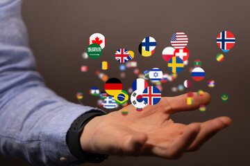 Image of a hand holding many flags representing global connections and international business.