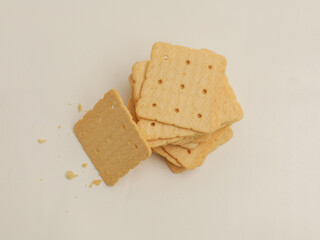 Square crackers piled on white background