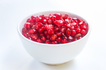 pomegranate seeds in a bowl isolated
