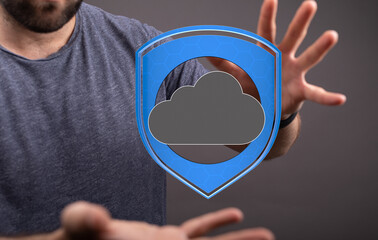 Image of a man safeguarding a cloud icon, symbolizing secure cloud data protection and...