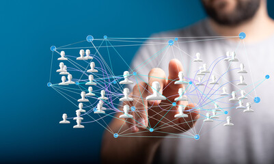Image of a hand interacting with a digital network of people, representing global connection and...