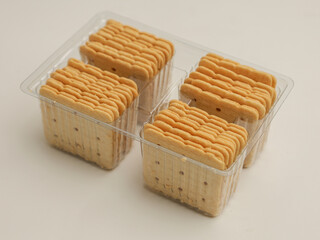 Square crackers piled on white background