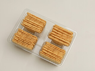 Square crackers piled on white background