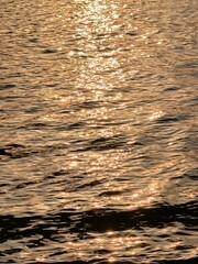 Golden blue sparkling water under the sunset