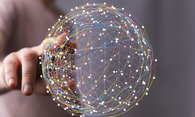 Abstract image of a hand interacting with a digital sphere representing global network connections and data flow.