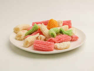 Savory rice crackers piled on white plate