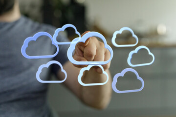 Person touching a digital cloud network, representing data storage, technology, and connectivity.