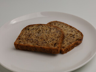 slice of banana bread on white background