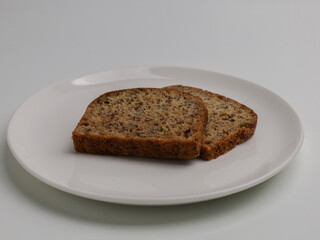 slice of banana bread on white background
