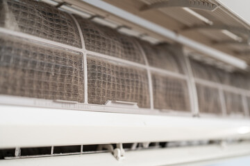 Dirty in dust and mold air conditioner filter close-up. Home air conditioner maintenance
