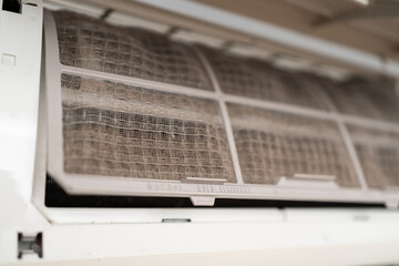 Dirty in dust and mold air conditioner filter close-up. Home air conditioner maintenance